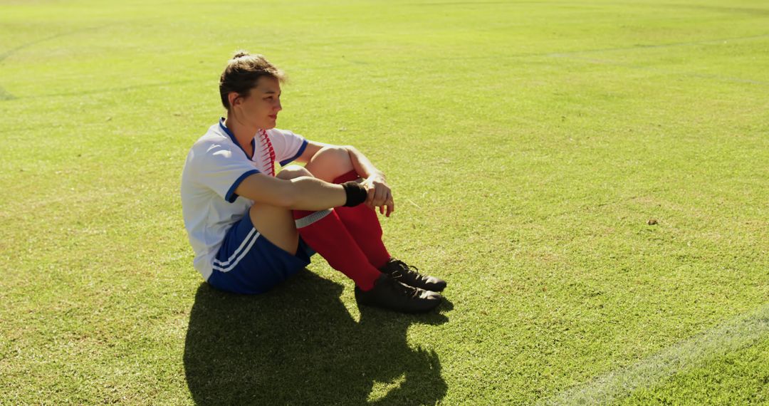 Teenage Soccer Player Sitting on Field in Contemplation - Free Images, Stock Photos and Pictures on Pikwizard.com