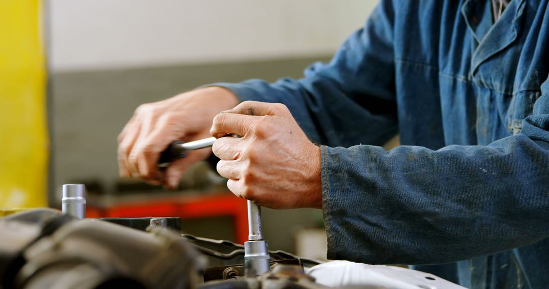 Mechanic repairing car engine using wrench at workshop - Free Images, Stock Photos and Pictures on Pikwizard.com