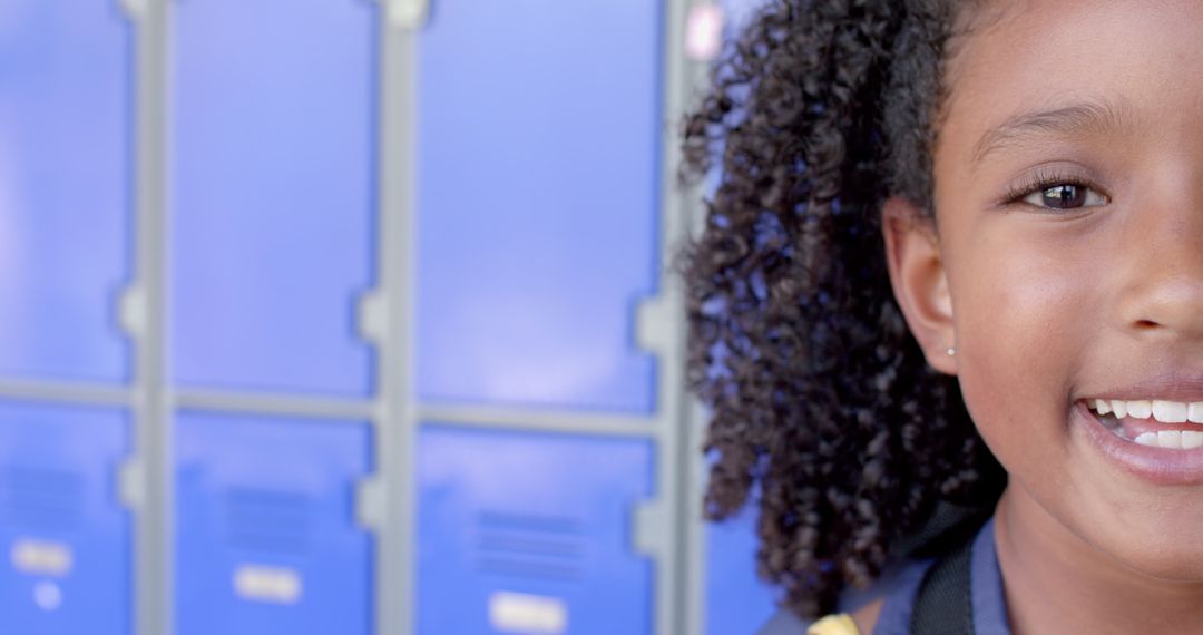 Smiling Child in School Hallway with Lockers