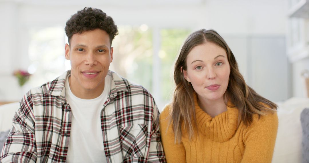 Cheerful Couple Enjoying Video Call on Couch at Home