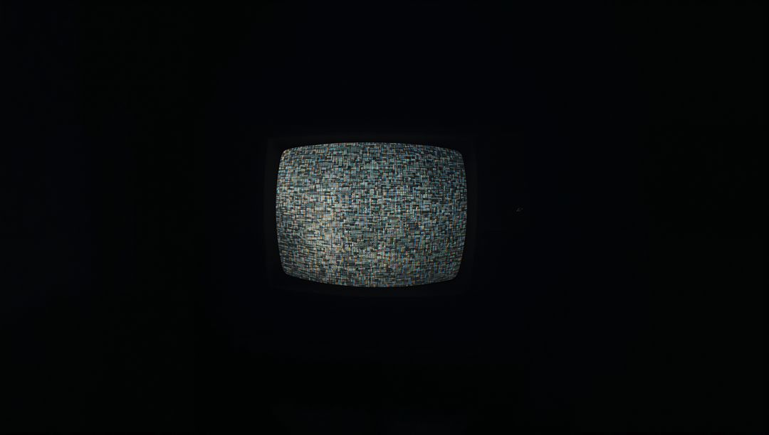 Retro CRT Television Showing Colorful Static in Dim Light