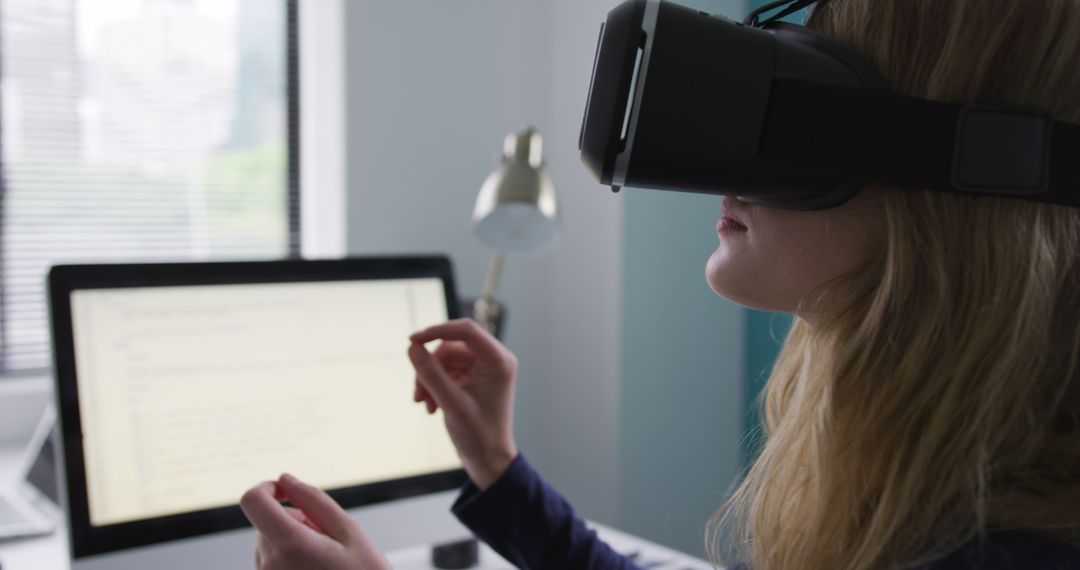 Woman Using Virtual Reality Headset at Desk - Free Images, Stock Photos and Pictures on Pikwizard.com