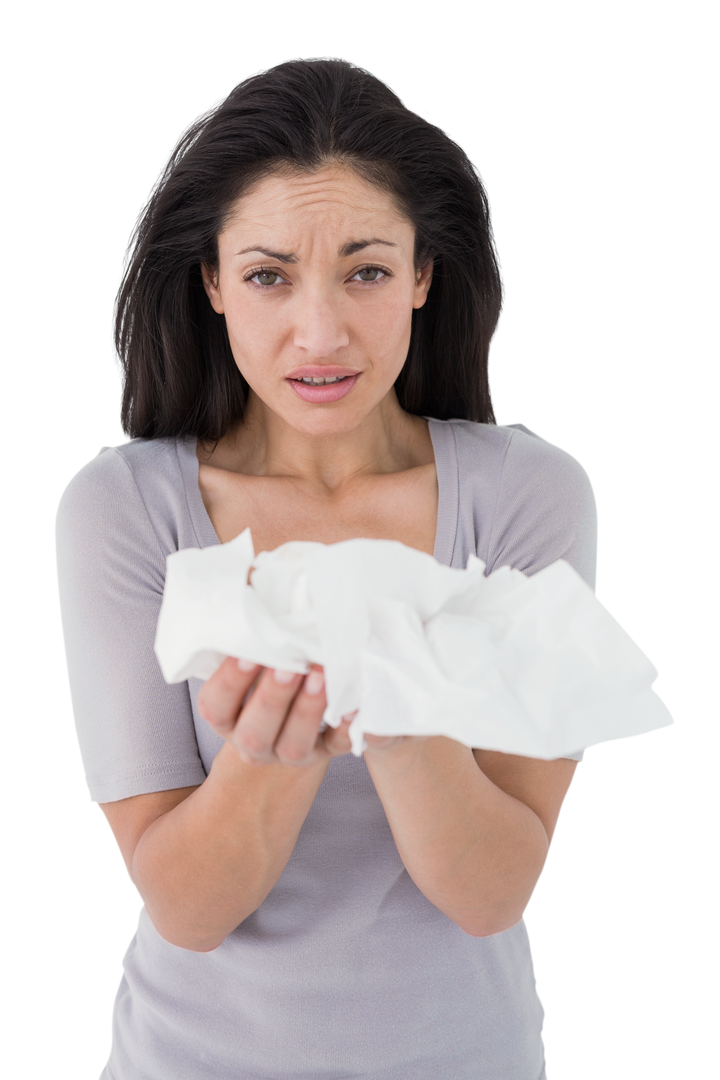 Sick brunette holding crumpled tissues looking at camera on transparent background - Download Free Stock Images Pikwizard.com