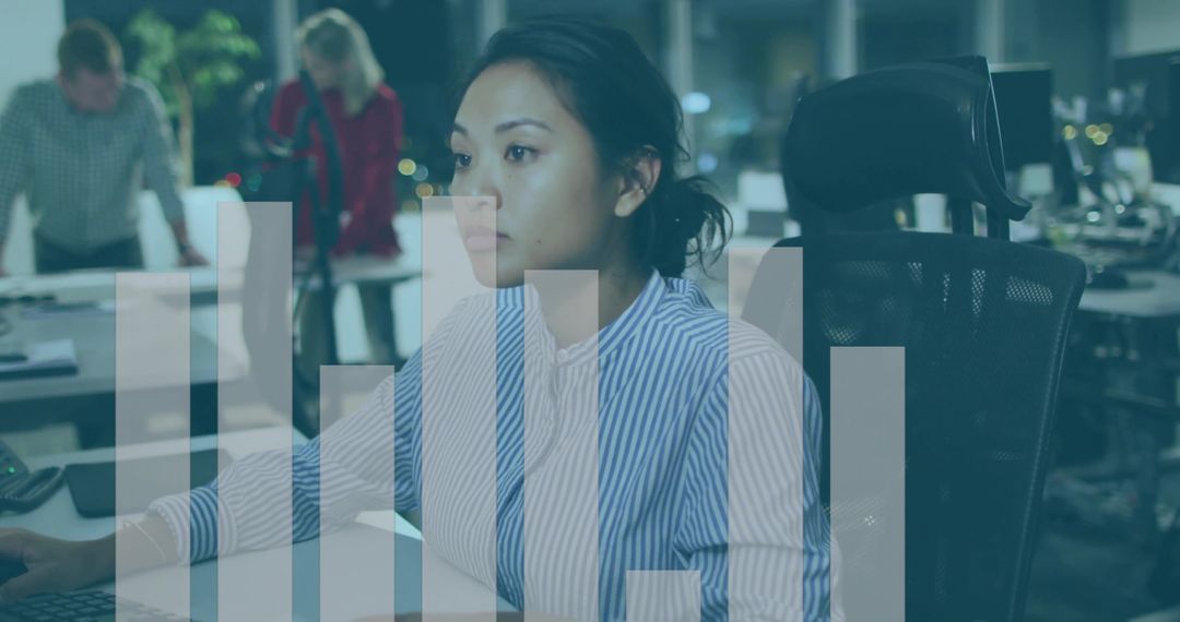 Asian woman working late in modern office analyzing data with translucent bar chart overlay