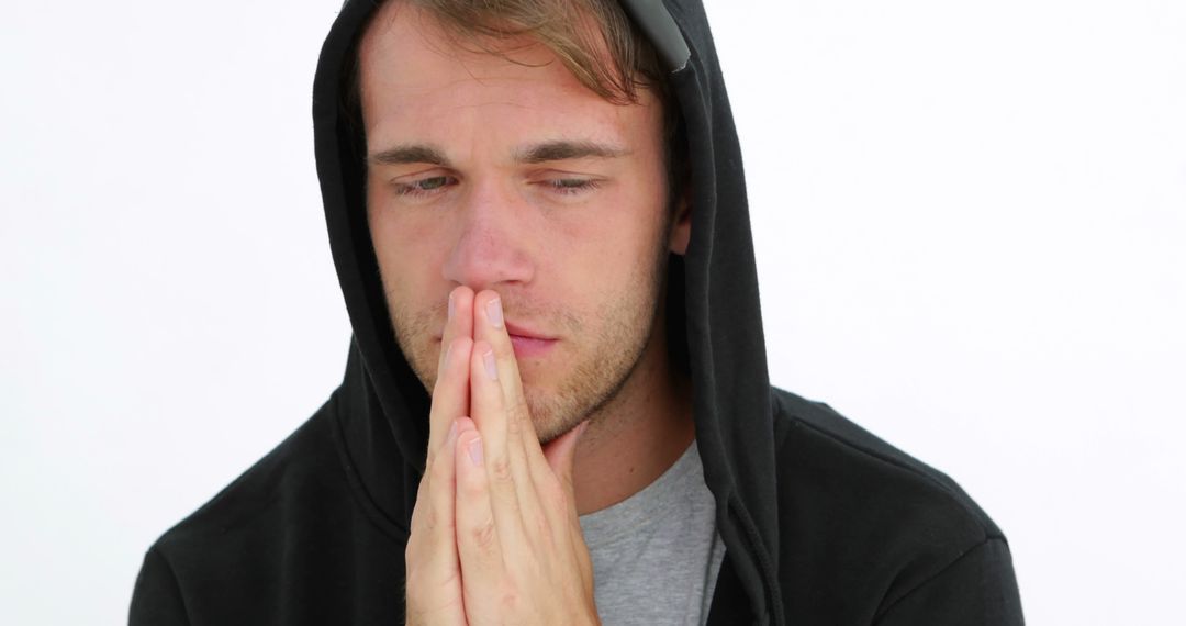 Desperate young man praying on white background - Free Images, Stock Photos and Pictures on Pikwizard.com