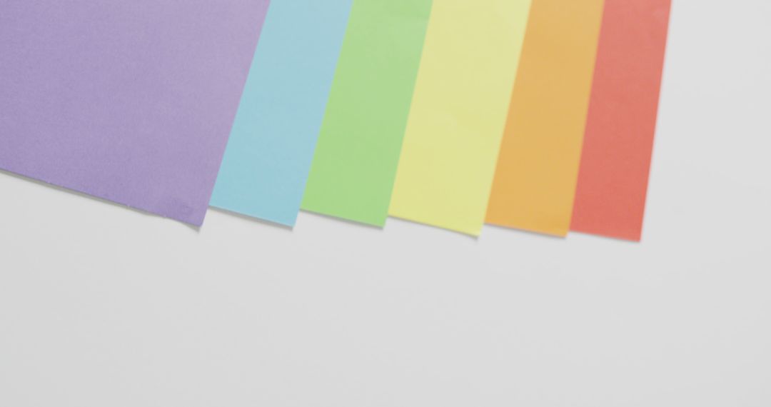 Image of rainbow sheets over white surface with copy space - Free Images, Stock Photos and Pictures on Pikwizard.com