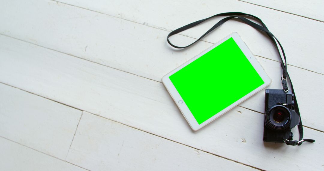 Digital Tablet with Green Screen and Camera on Wooden Floor - Free Images, Stock Photos and Pictures on Pikwizard.com