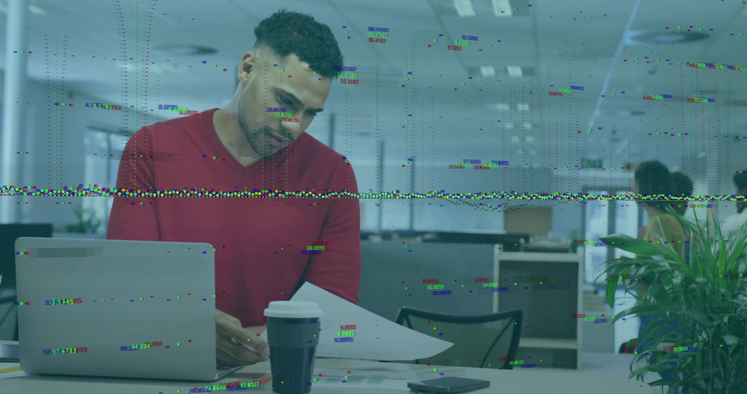 Focused Professional Reviewing Documents in Modern Workspace