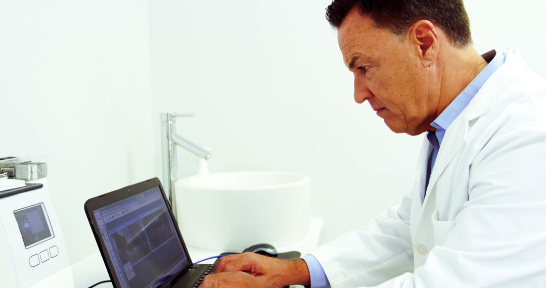 Senior Doctor Analyzing X-ray Results on Laptop in Modern Clinic - Free Images, Stock Photos and Pictures on Pikwizard.com