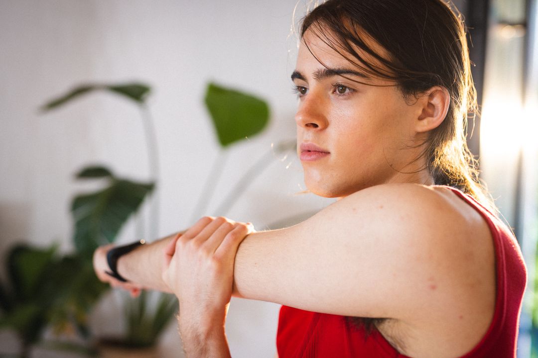 Non-Binary Trans Person Stretching at Home