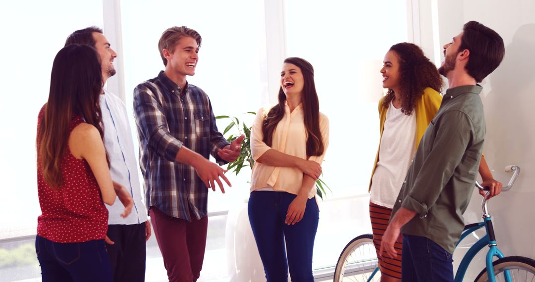 Diverse Group of Young Adults Enjoying Casual Conversation Indoors