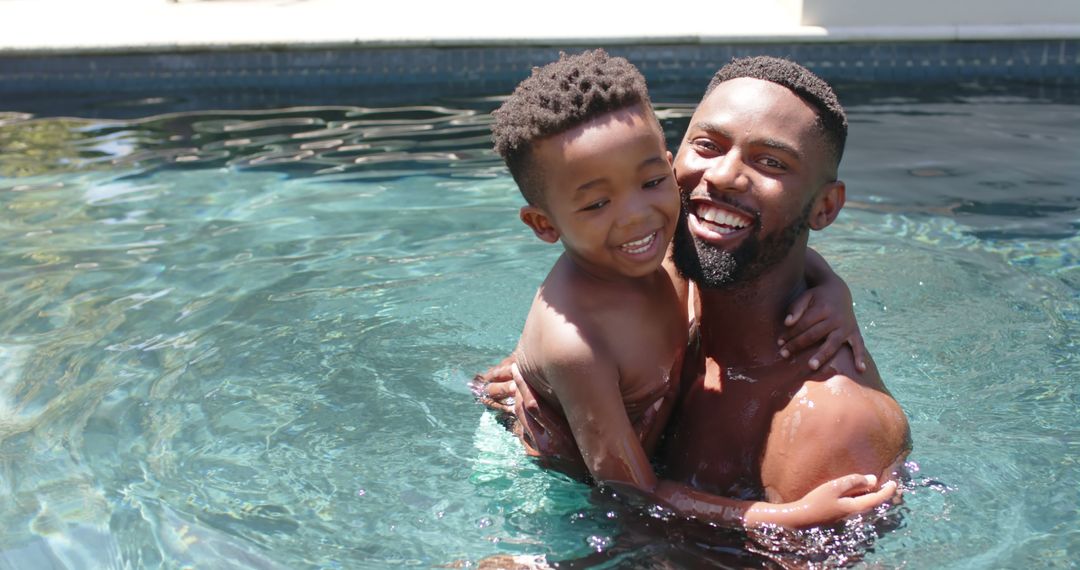 Happy Father and Son Embracing in Swimming Pool on Sunny Day - Free Images, Stock Photos and Pictures on Pikwizard.com