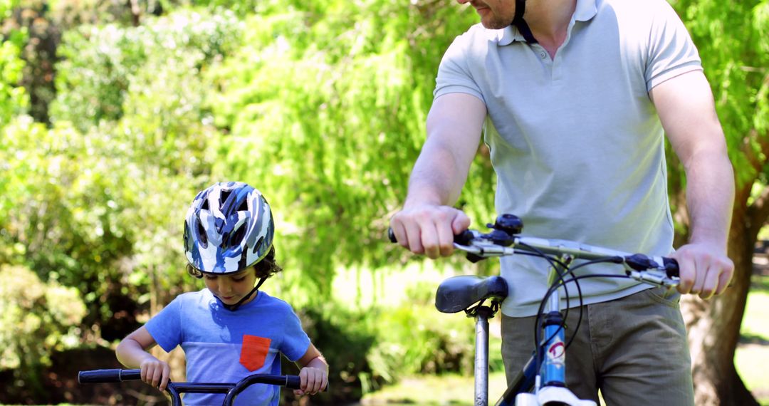 Father and Son Enjoying Biking in Park - Free Images, Stock Photos and Pictures on Pikwizard.com