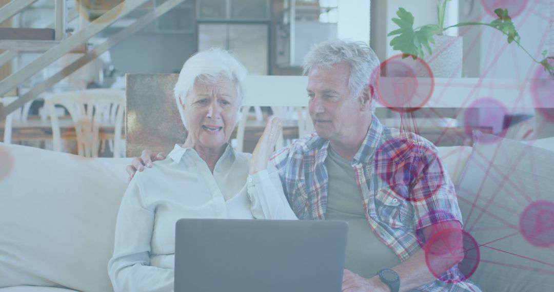 Senior Couple Exploring Digital Network on a Laptop at Home