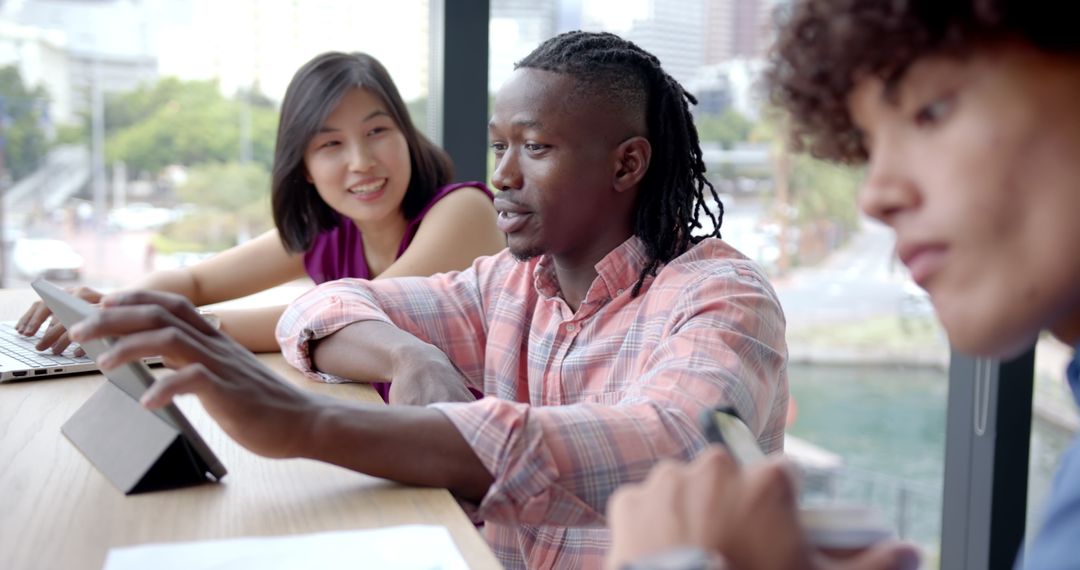Diverse Team Collaborating on Project with Tablet in Office
