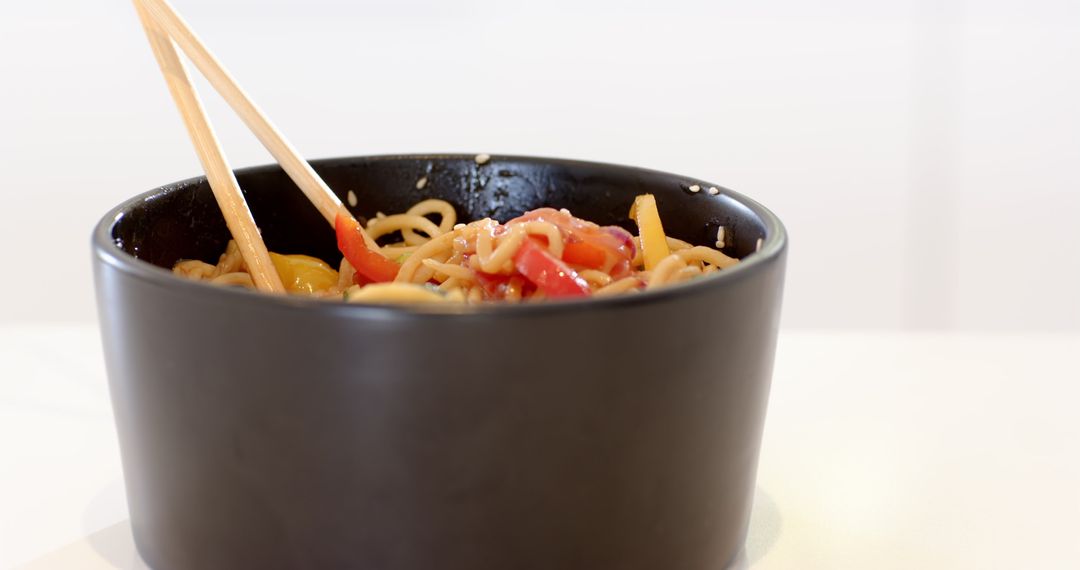 Asian Noodles with Bell Peppers and Sesame in Minimalist Setting