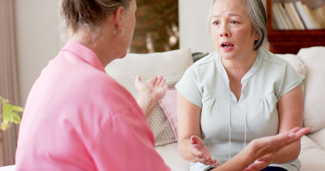 Two Senior Women Engaging in an Intense Conversation at Home