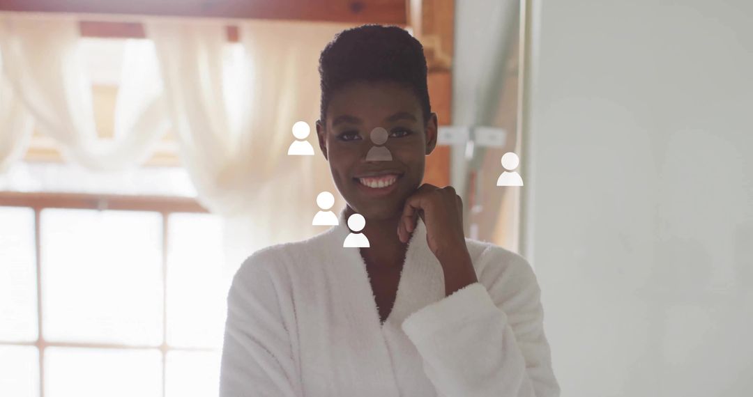 Smiling woman wearing white bathrobe at vanity with social user icon overlay and natural light