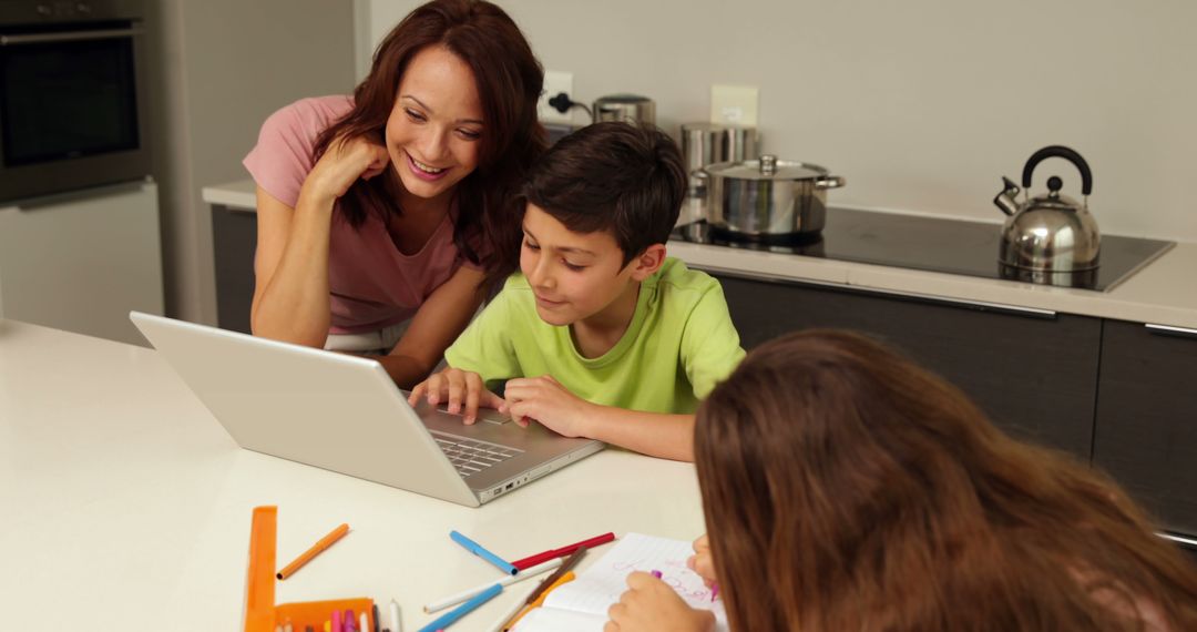 Mother Helping Children with Homework on Laptop in Kitchen - Free Images, Stock Photos and Pictures on Pikwizard.com