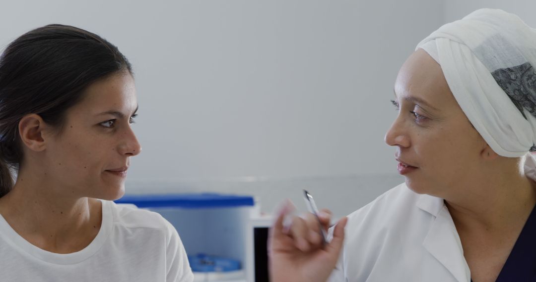 Doctor Conversing with Female Patient in Medical Facility - Free Images, Stock Photos and Pictures on Pikwizard.com