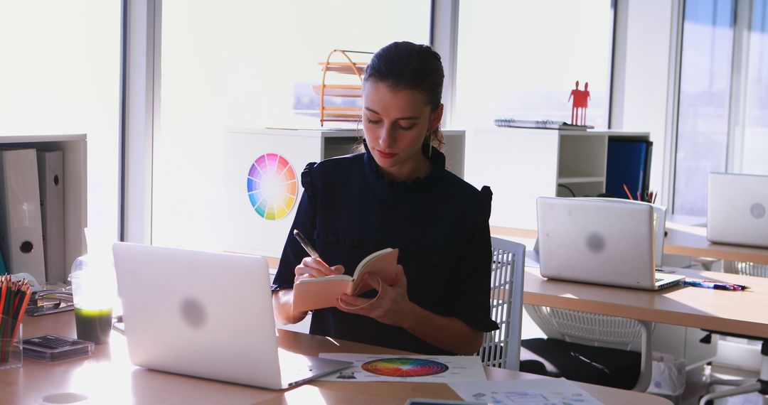 Creative Professional Writing at Office Desk in Daylight Workspace