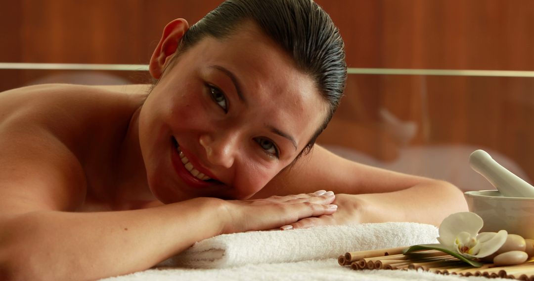 Woman Relaxing in Spa with Orchids and Towels - Free Images, Stock Photos and Pictures on Pikwizard.com