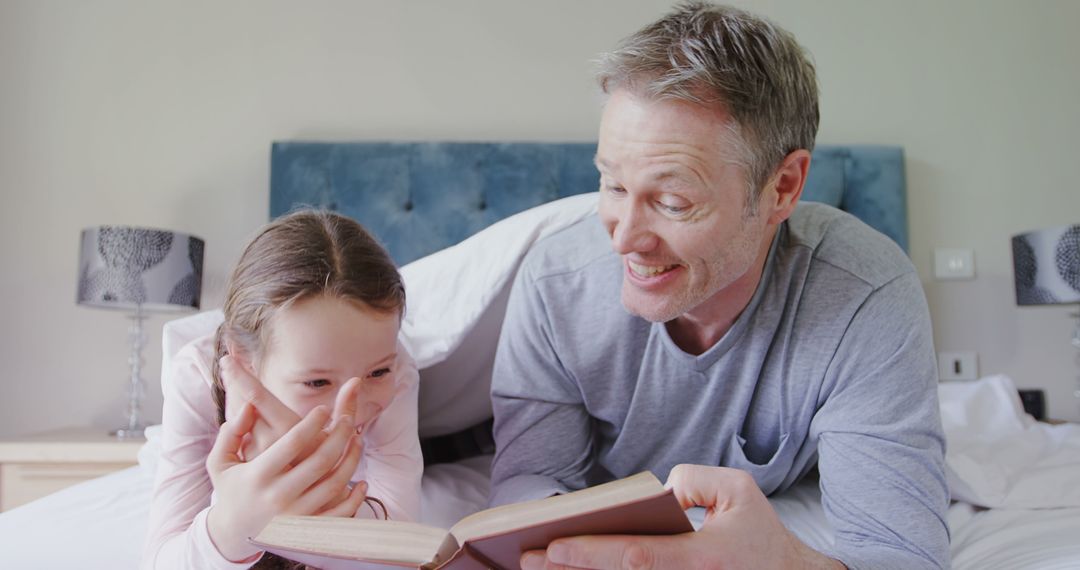 Father Reading Book to Daughter at Home - Free Images, Stock Photos and Pictures on Pikwizard.com