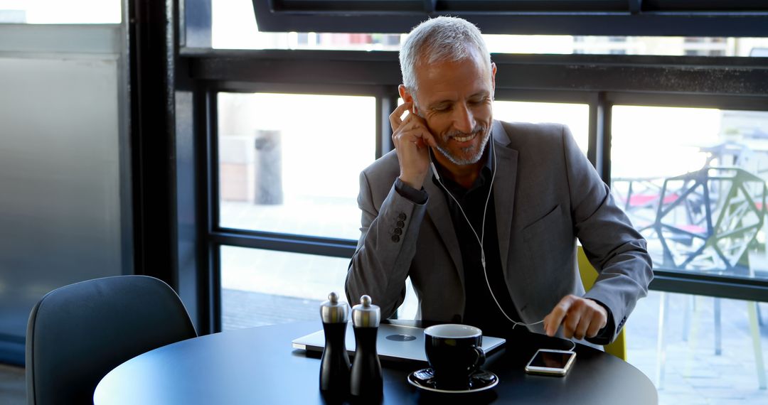 Smiling Businessman Making a Call in Modern Coffee Shop - Free Images, Stock Photos and Pictures on Pikwizard.com