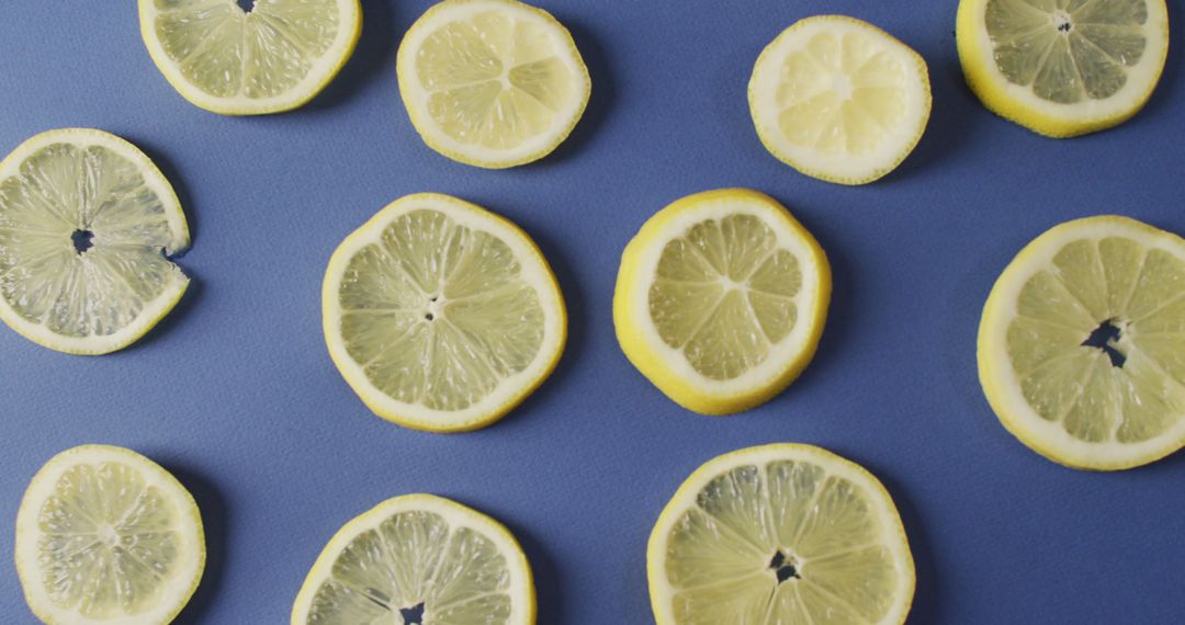 Image of slices of lemon lying on blue background - Free Images, Stock Photos and Pictures on Pikwizard.com