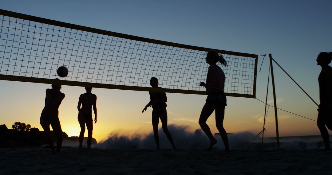 Group of Friends Playing Beach Volleyball at Sunset - Free Images, Stock Photos and Pictures on Pikwizard.com