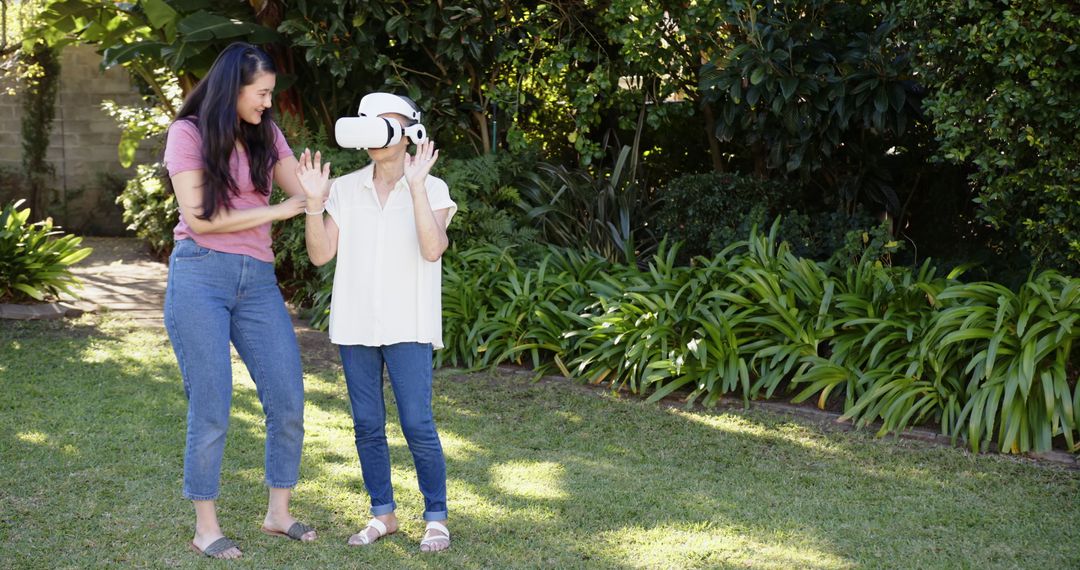 Mother and Daughter Using Virtual Reality Headset in Backyard