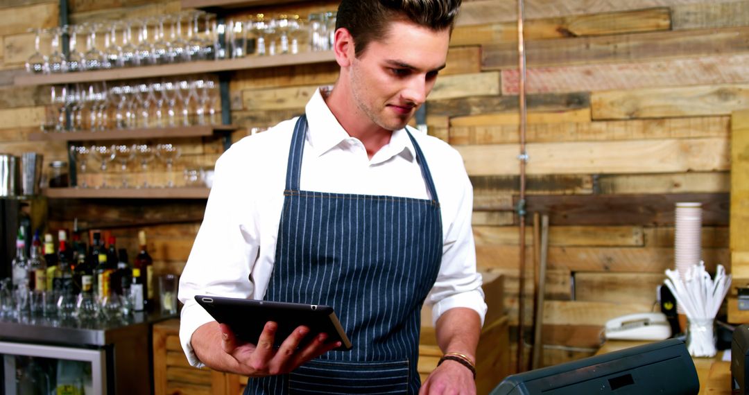 Barista using tablet and cash register in trendy cafe - Free Images, Stock Photos and Pictures on Pikwizard.com