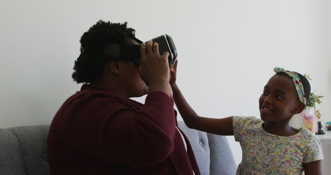 Mother and Daughter Using Virtual Reality Headset at Home - Free Images, Stock Photos and Pictures on Pikwizard.com