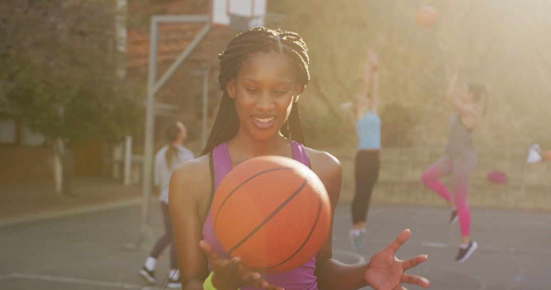 Portrait of african american female basketball player holding ball and looking at camera - Free Images, Stock Photos and Pictures on Pikwizard.com