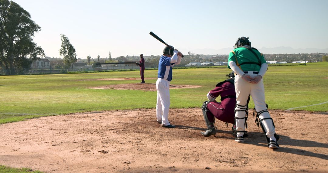 Baseball Players Ready for Pitch on Sunny Field
