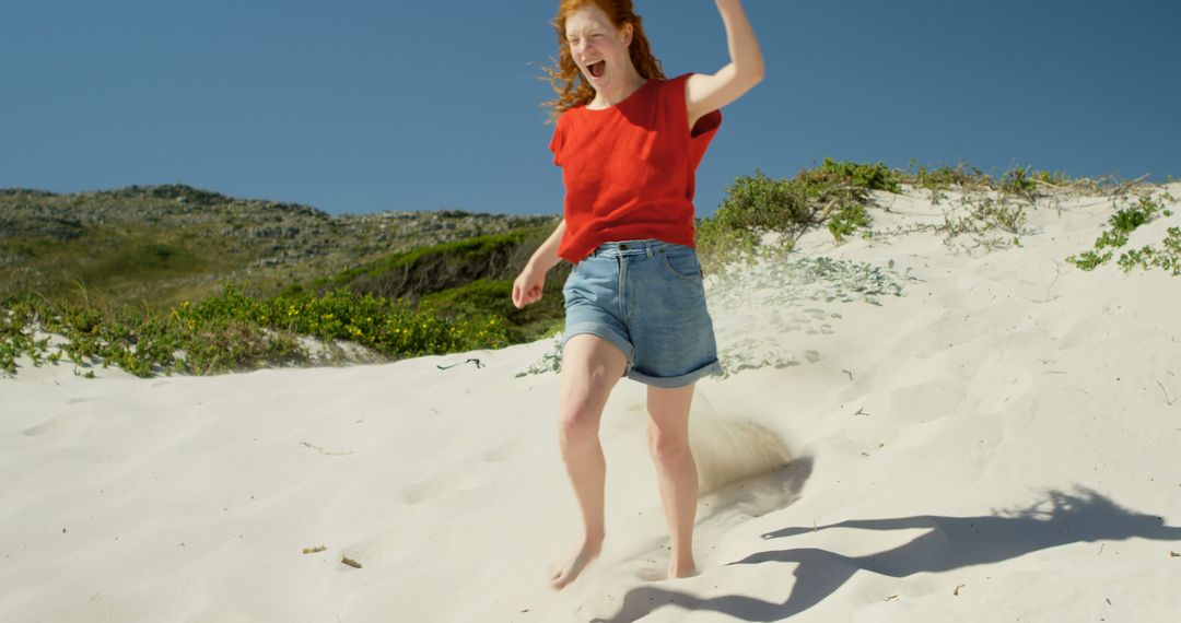 Joyful Woman Running on Sandy Beach on a Sunny Day - Free Images, Stock Photos and Pictures on Pikwizard.com