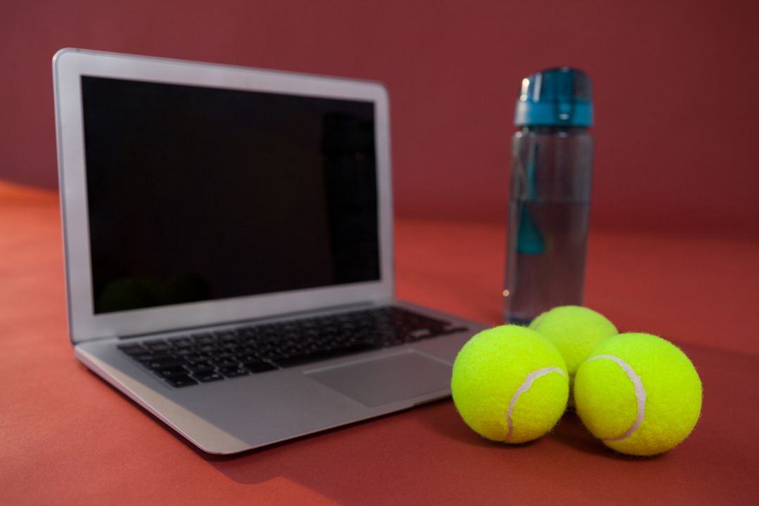Close up of tennis balls by laptop and water bottle - Free Images, Stock Photos and Pictures on Pikwizard.com