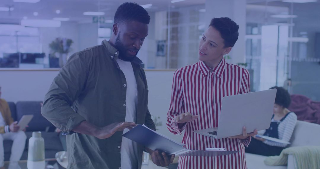 Collaborative Office Work Discussing Reports Laptops