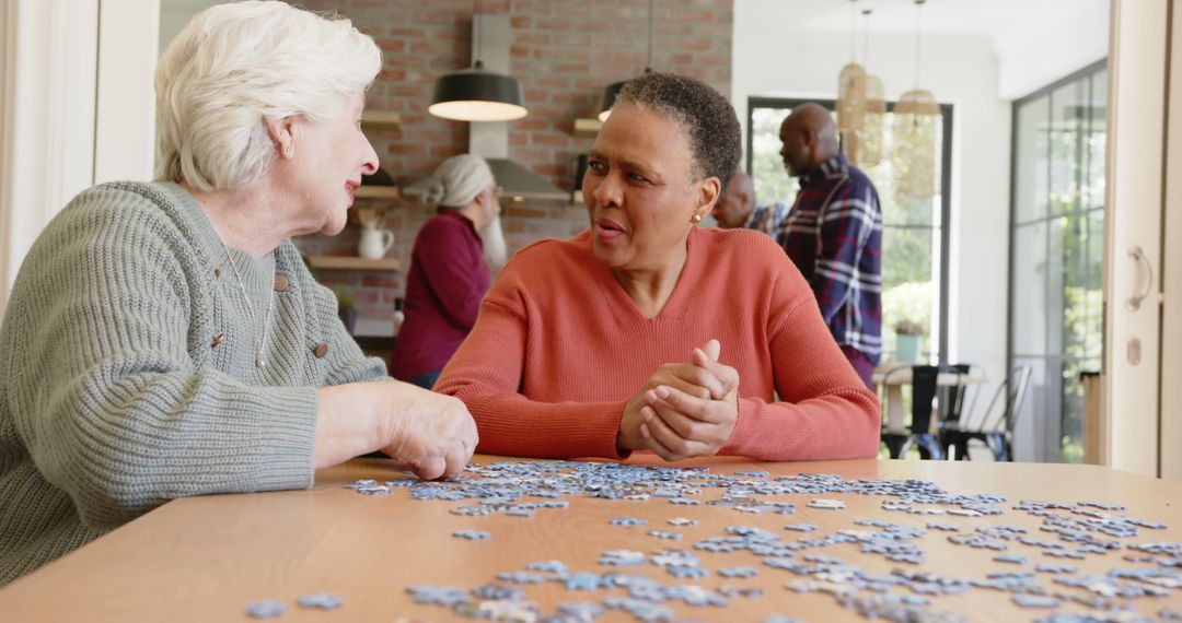 Senior Women Socializing and Doing Puzzle Together at Home - Free Images, Stock Photos and Pictures on Pikwizard.com