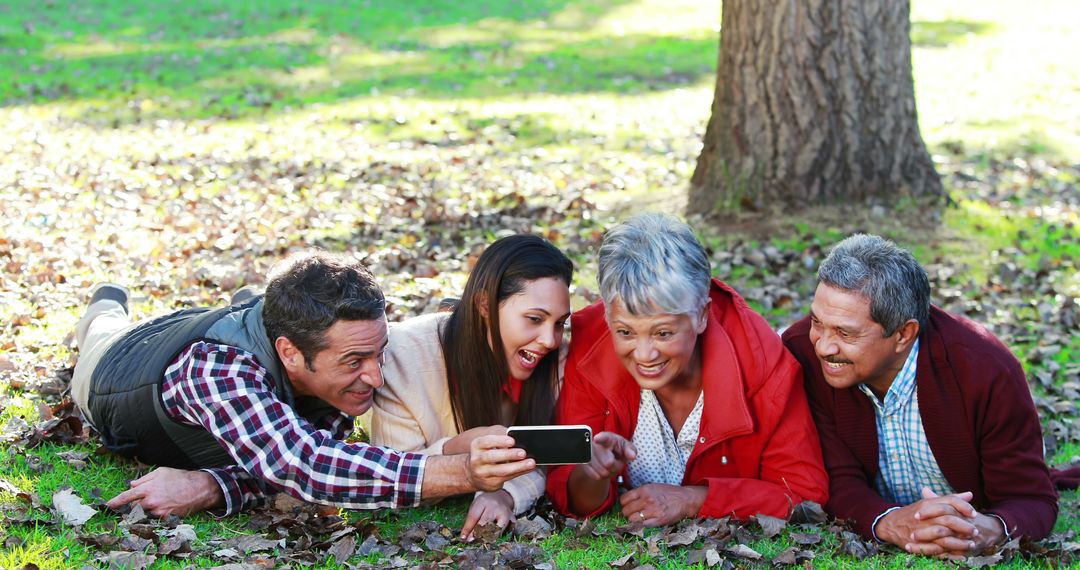 Multi-generational Family Enjoying Autumn Day Taking Selfie Outdoors - Free Images, Stock Photos and Pictures on Pikwizard.com