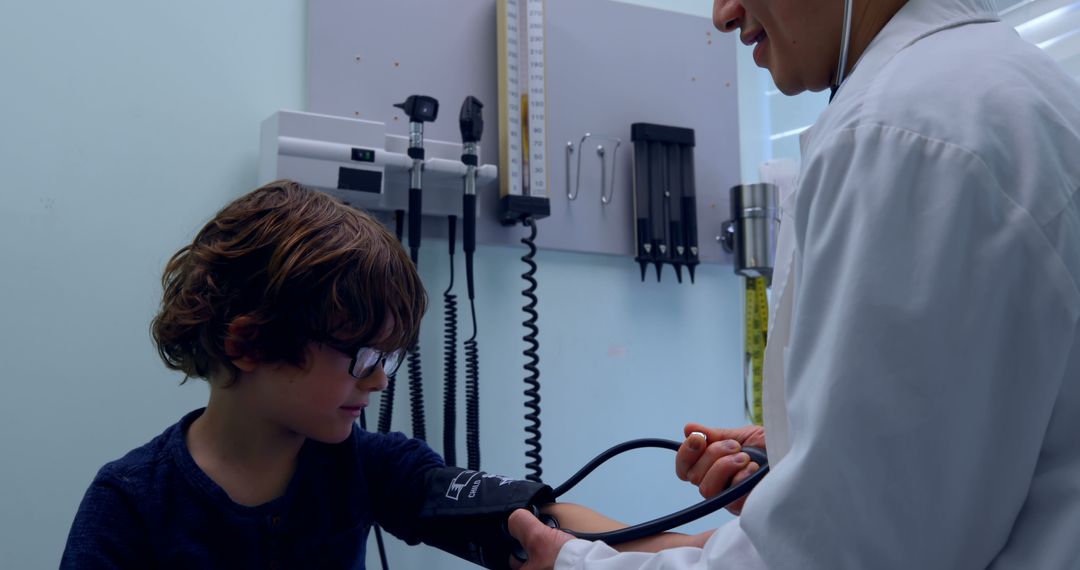 Pediatrician Measuring Young Boy's Blood Pressure in Clinic - Free Images, Stock Photos and Pictures on Pikwizard.com