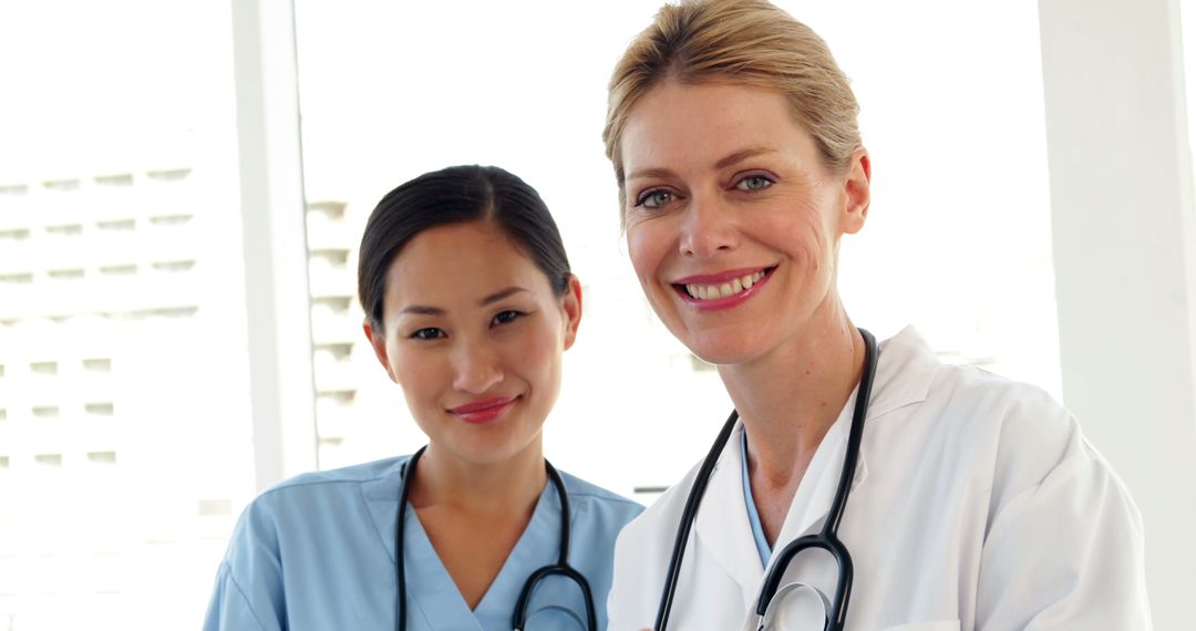 Smiling Female Doctors Standing Together in Hospital - Free Images, Stock Photos and Pictures on Pikwizard.com