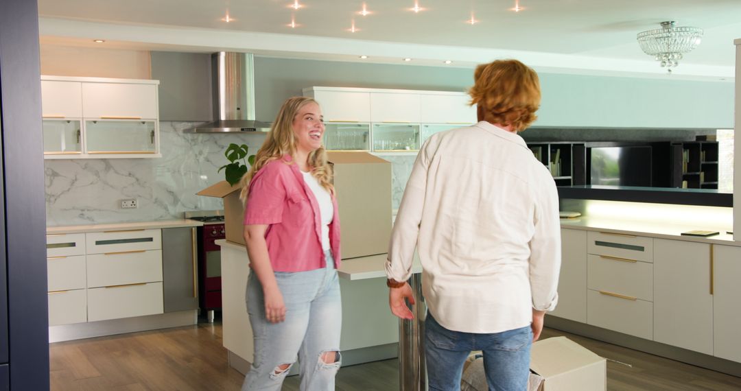 Couple Enjoying Unpacking in New Kitchen