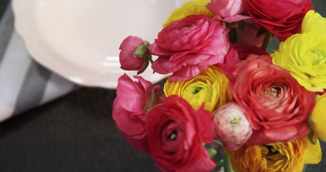 Colorful Ranunculus Flowers Bouquet on Dark Surface - Free Images, Stock Photos and Pictures on Pikwizard.com