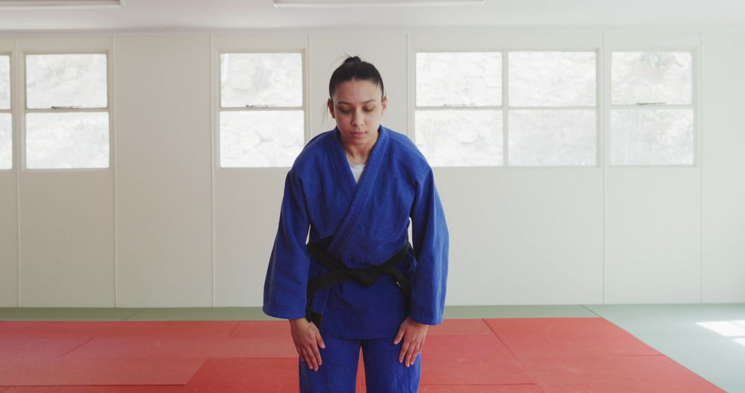 Female Judo Practitioner Bowing in Martial Arts Dojo - Free Images, Stock Photos and Pictures on Pikwizard.com