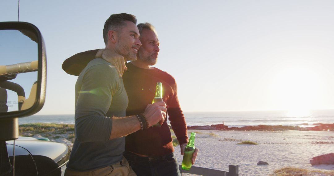 Two Friends Enjoying Beer on Beach at Sunset - Free Images, Stock Photos and Pictures on Pikwizard.com