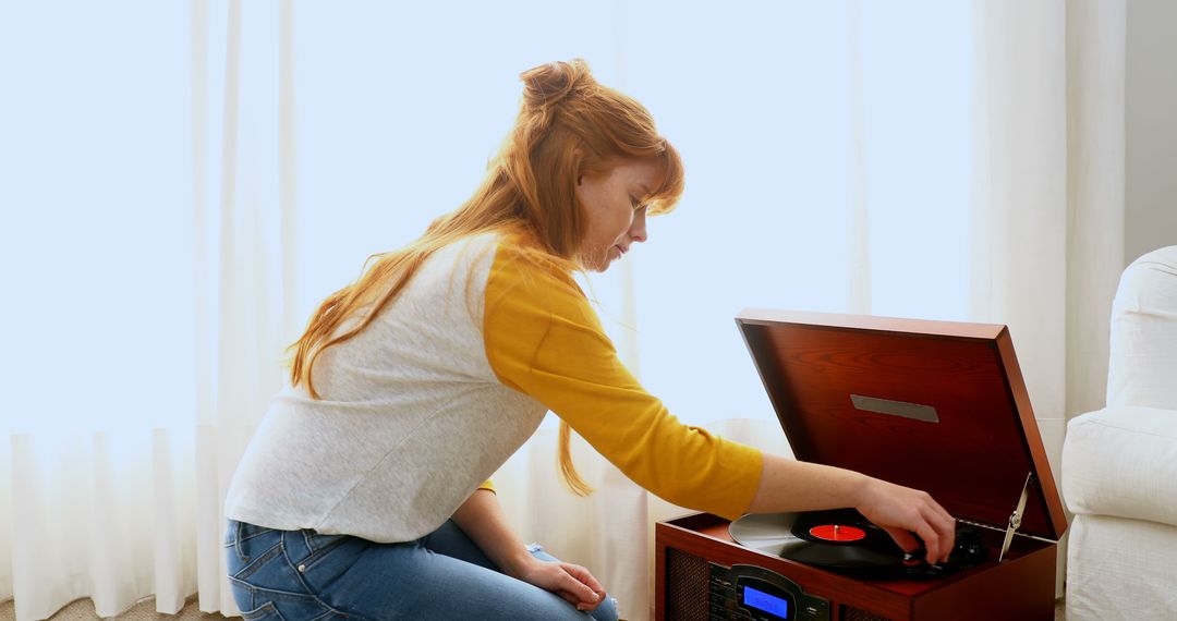 Young Woman Using Vintage Turntable in Bright Room - Free Images, Stock Photos and Pictures on Pikwizard.com