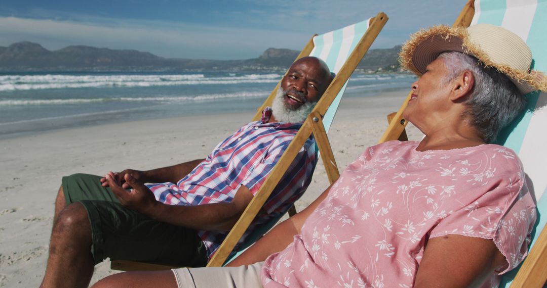 Senior Couple Relaxing on Beach Chairs at Scenic Sunny Beach - Free Images, Stock Photos and Pictures on Pikwizard.com