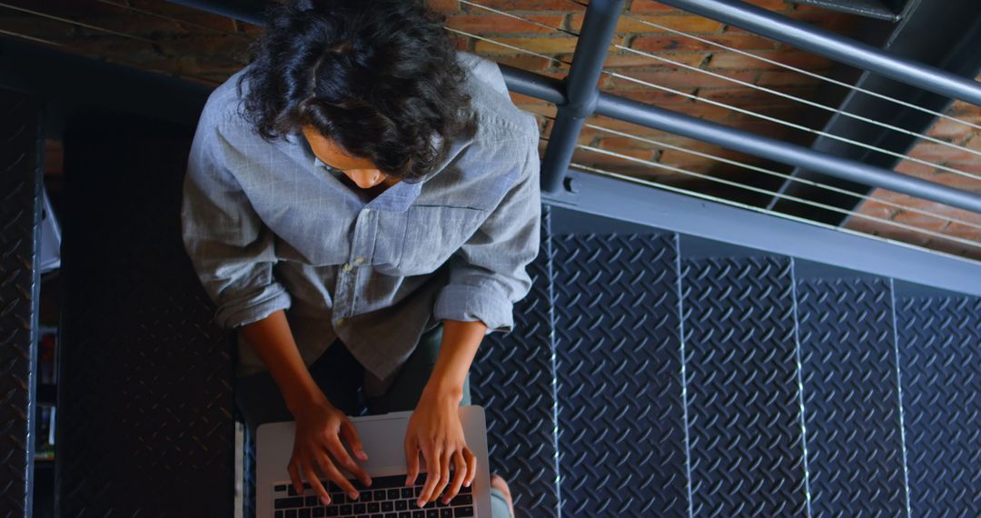 Top view of person typing on laptop keyboard on stairs - Free Images, Stock Photos and Pictures on Pikwizard.com