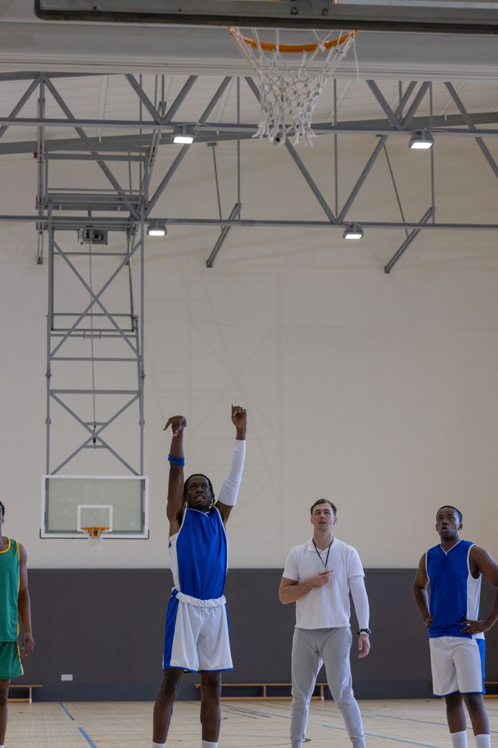 Diverse Male Basketball Team Practicing Free Throws in Gym